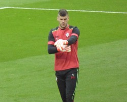 <h4>Fraser Forster</h4>Saints goalie alone in his thoughts and adjusting his gloves